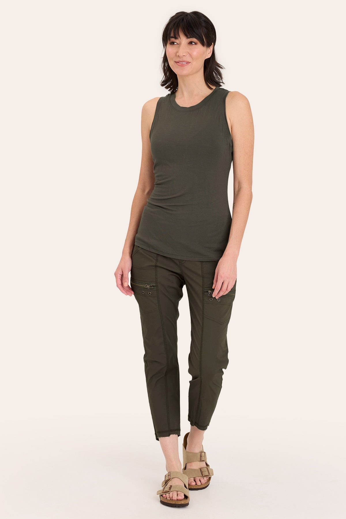 Core by Acker Zipper Slim Crop with shirred panels, zipper pockets, and raw-edge distressed rounded hem in Green - XCVI