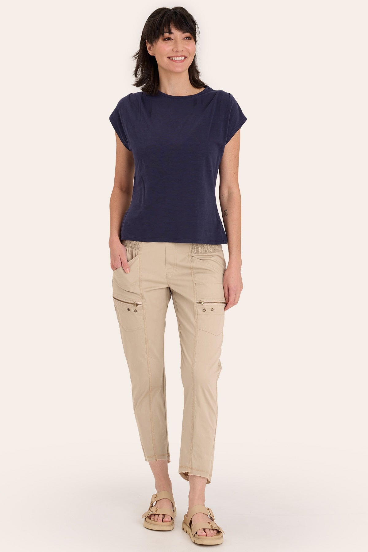 Core by Acker Zipper Slim Crop with shirred panels, zipper pockets, and raw-edge distressed rounded hem in Beige - XCVI