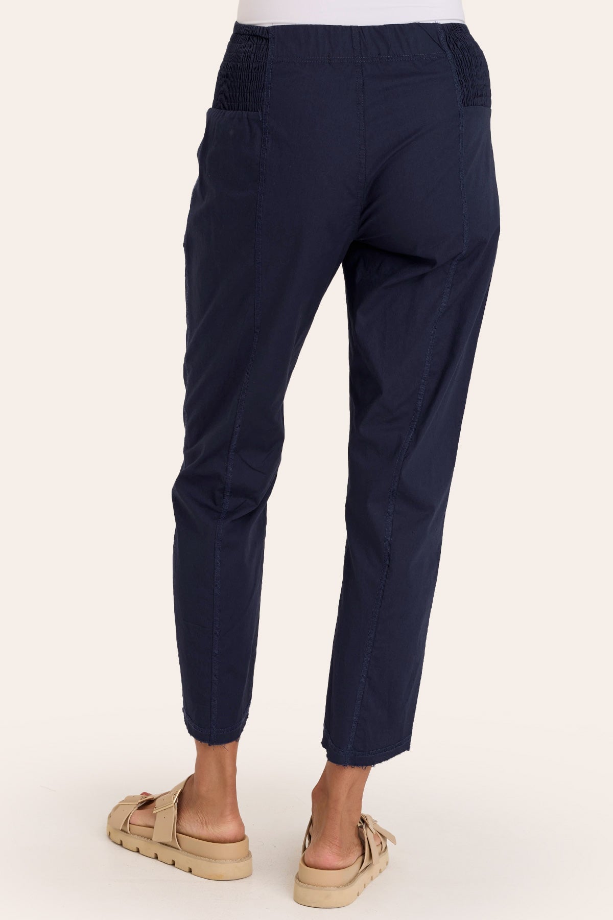 Core by Acker Zipper Slim Crop with shirred panels, zipper pockets, and raw-edge distressed rounded hem in Blue  - XCVI