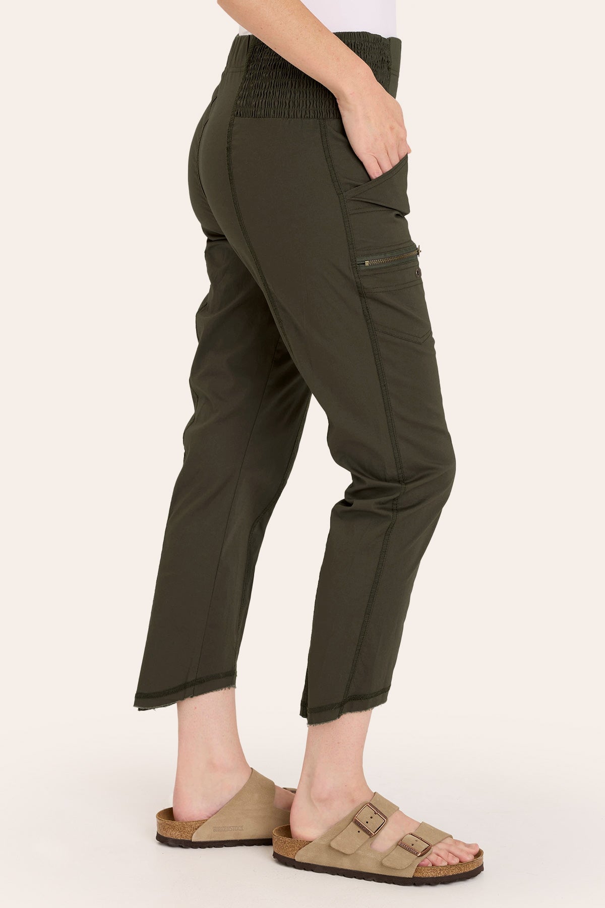Core by Acker Zipper Slim Crop with shirred panels, zipper pockets, and raw-edge distressed rounded hem in Green  - XCVI