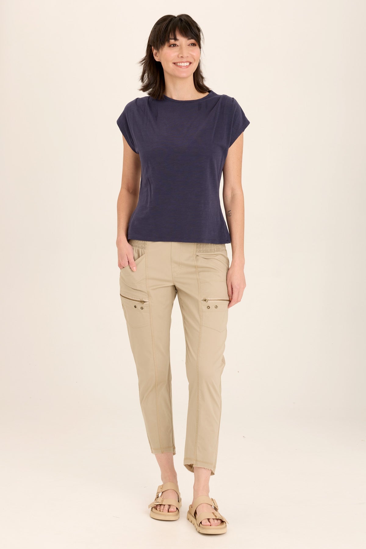 Wearables Acker Zipper Slim Crop with shirred panels, zipper pockets, and raw-edge distressed rounded hem in Beige  - XCVI